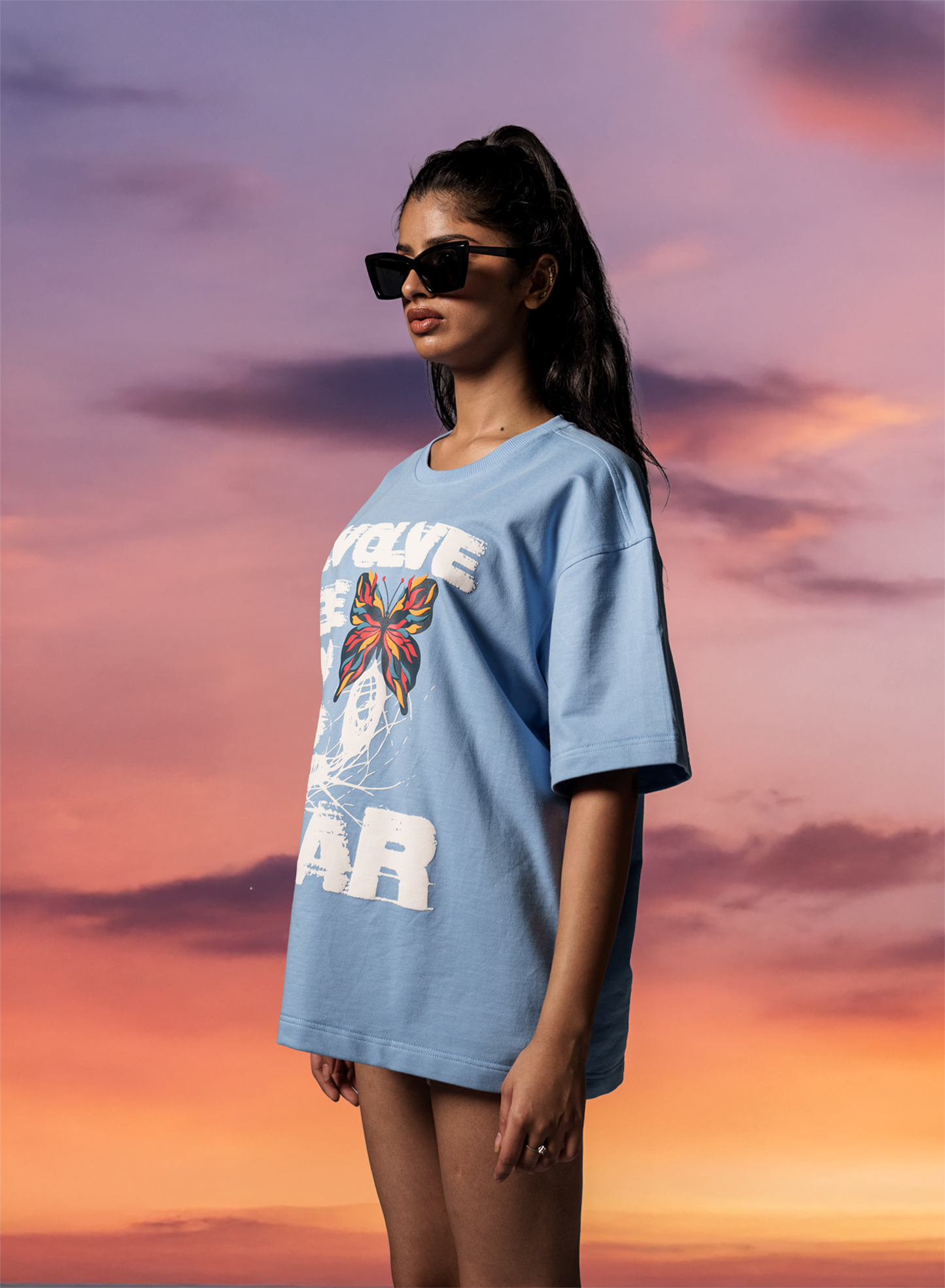 Blue oversized Evolve T-shirt side-profile showing puff-print