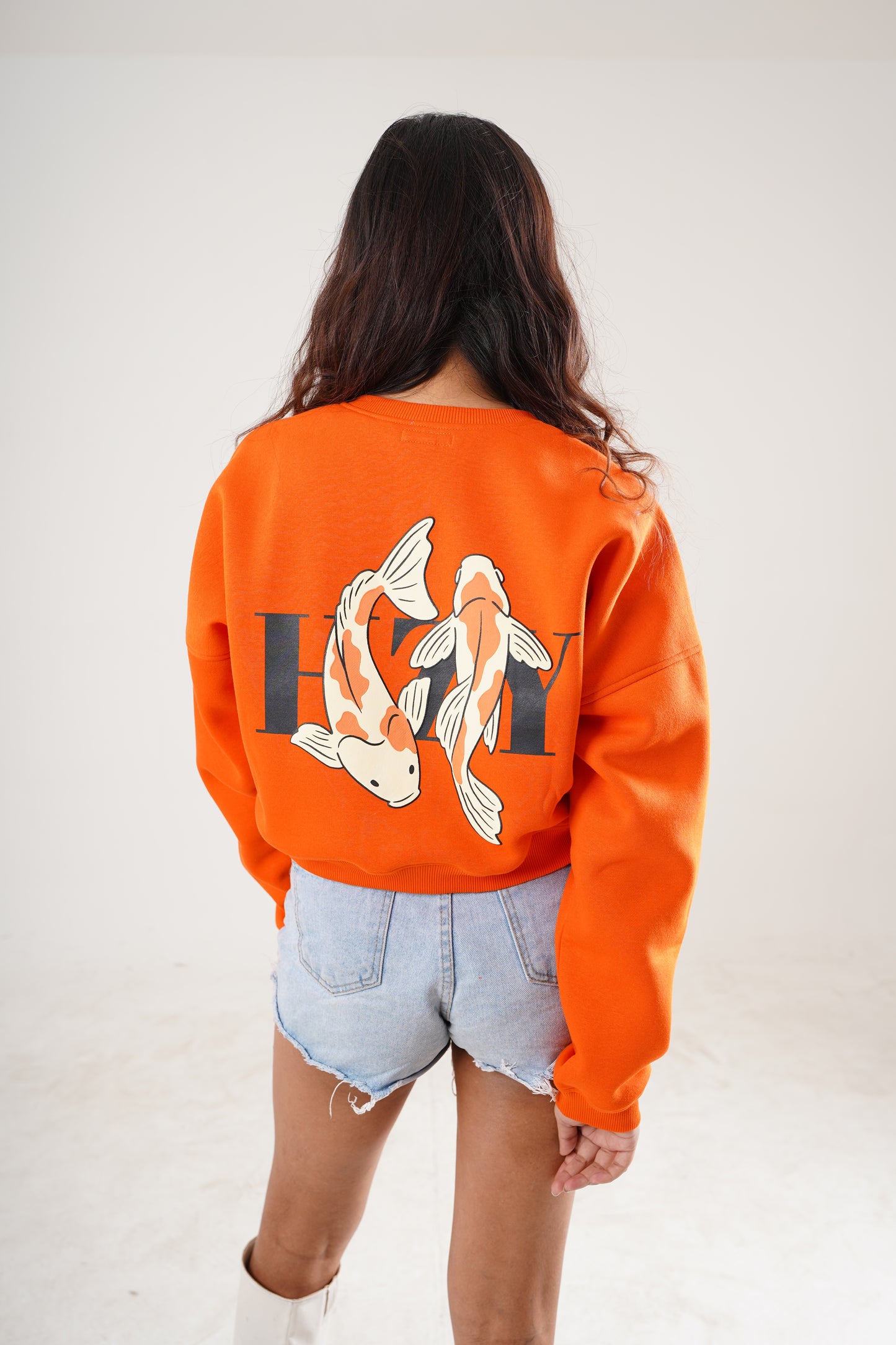 Streetwear sweatshirt in orange with flame fish graphic and bold text