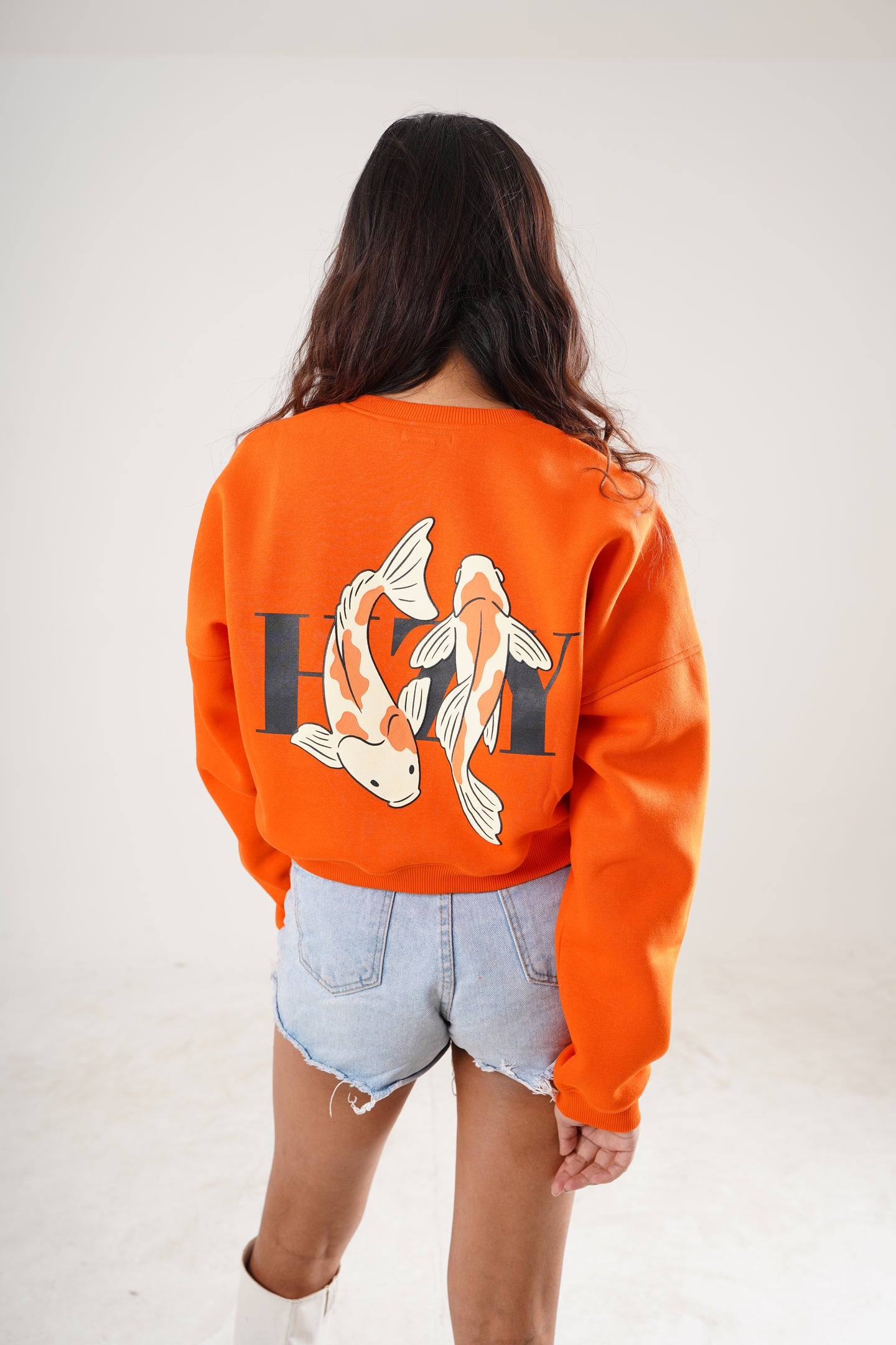 Streetwear sweatshirt in orange with flame fish graphic and bold text