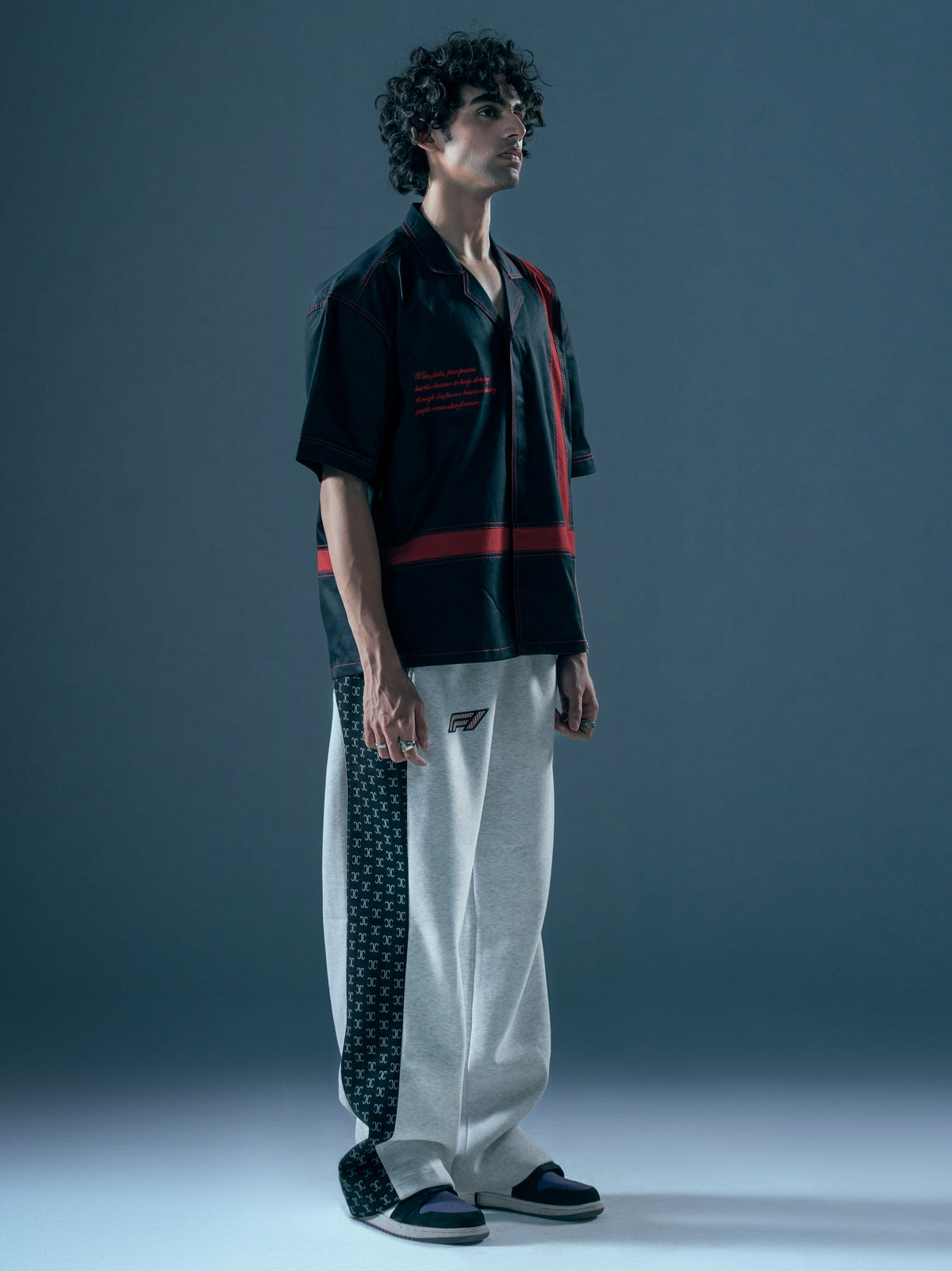 black shirt with red stripes on sleeves